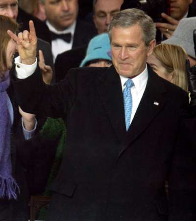 George W. Bush, a Freemason and a member of the Bohemian Club and Skull and Bones,
		showing the Satanic sign of Horned Hand or The Mano Cornuto